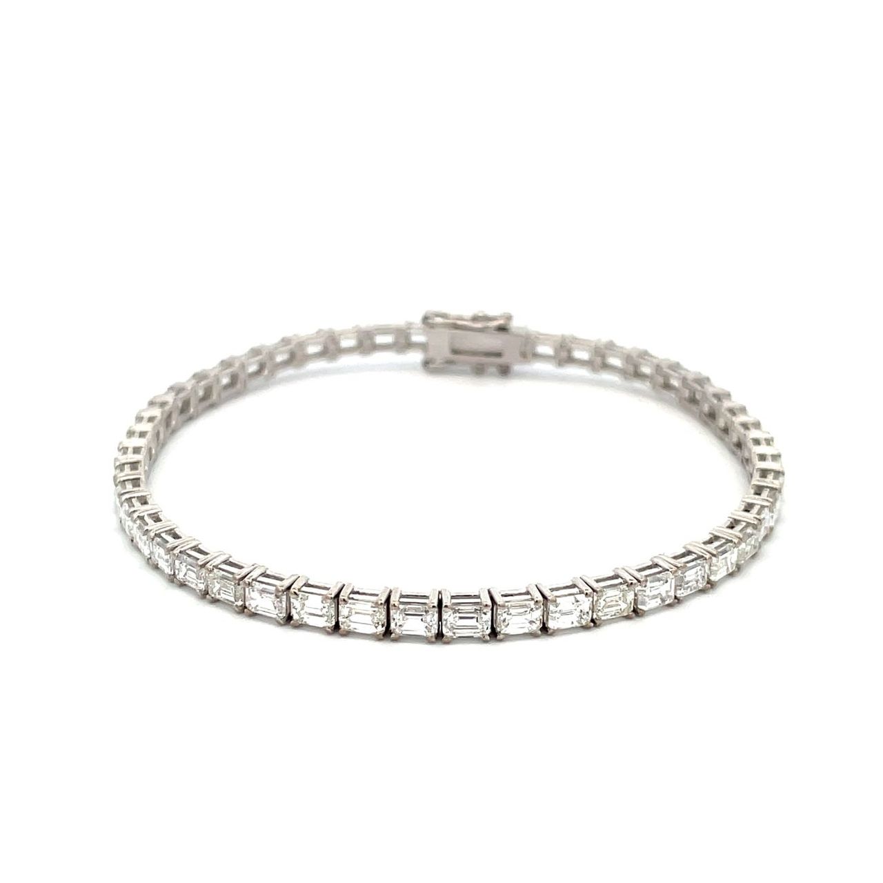 7' Tennis bracelet east west style in 18K WG with basket prong set (48) emerald cut diamonds.  D6.97ct.t.w.
