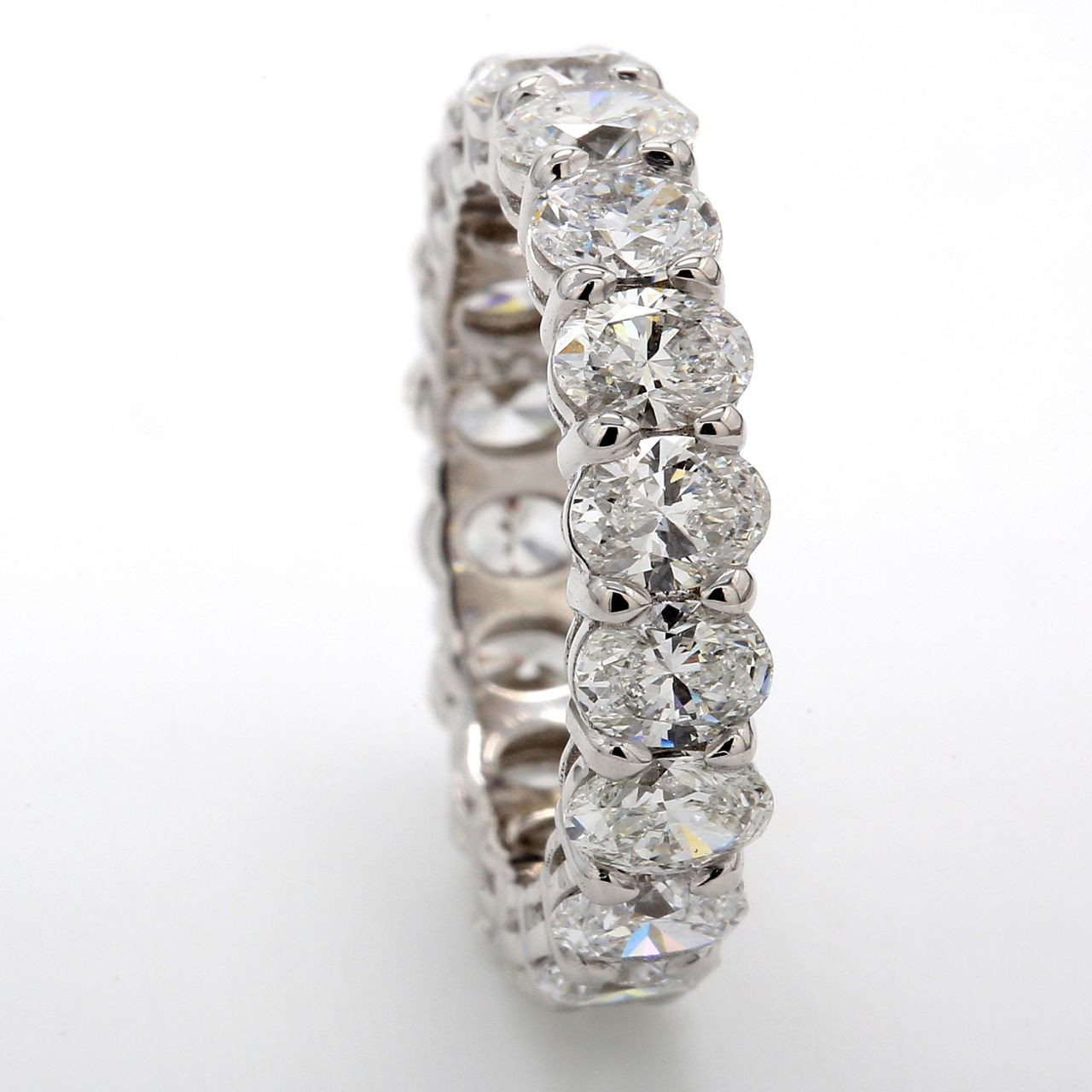 Eternity band in platinum with basket set (18) oval diamonds.  D4.38ct.t.w.  Size 5.75
