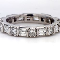 Eternity band bypass style in platinum with prong set (10) emerald cut and (10) princess cut diamonds.  D2.22ct.t.w.  Size 6.25