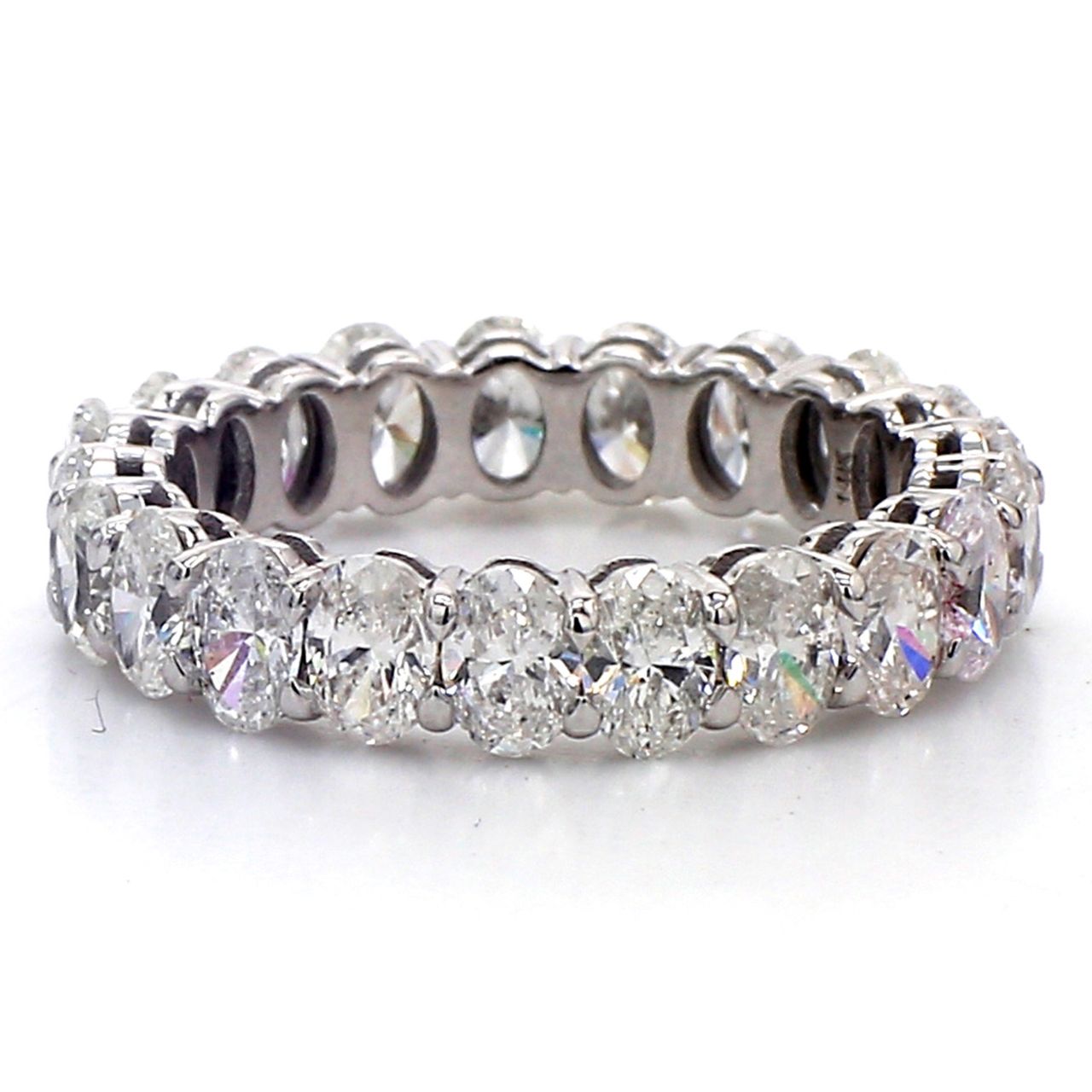 Eternity band in white gold with basket prong set (21) oval cut diamonds.  D2.89ct.t.w.  Size 4.75