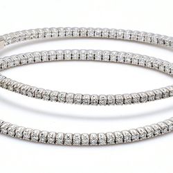 Inside out hoop earrings with 4-prong set round diamonds.  D3.42ct.t.w.
