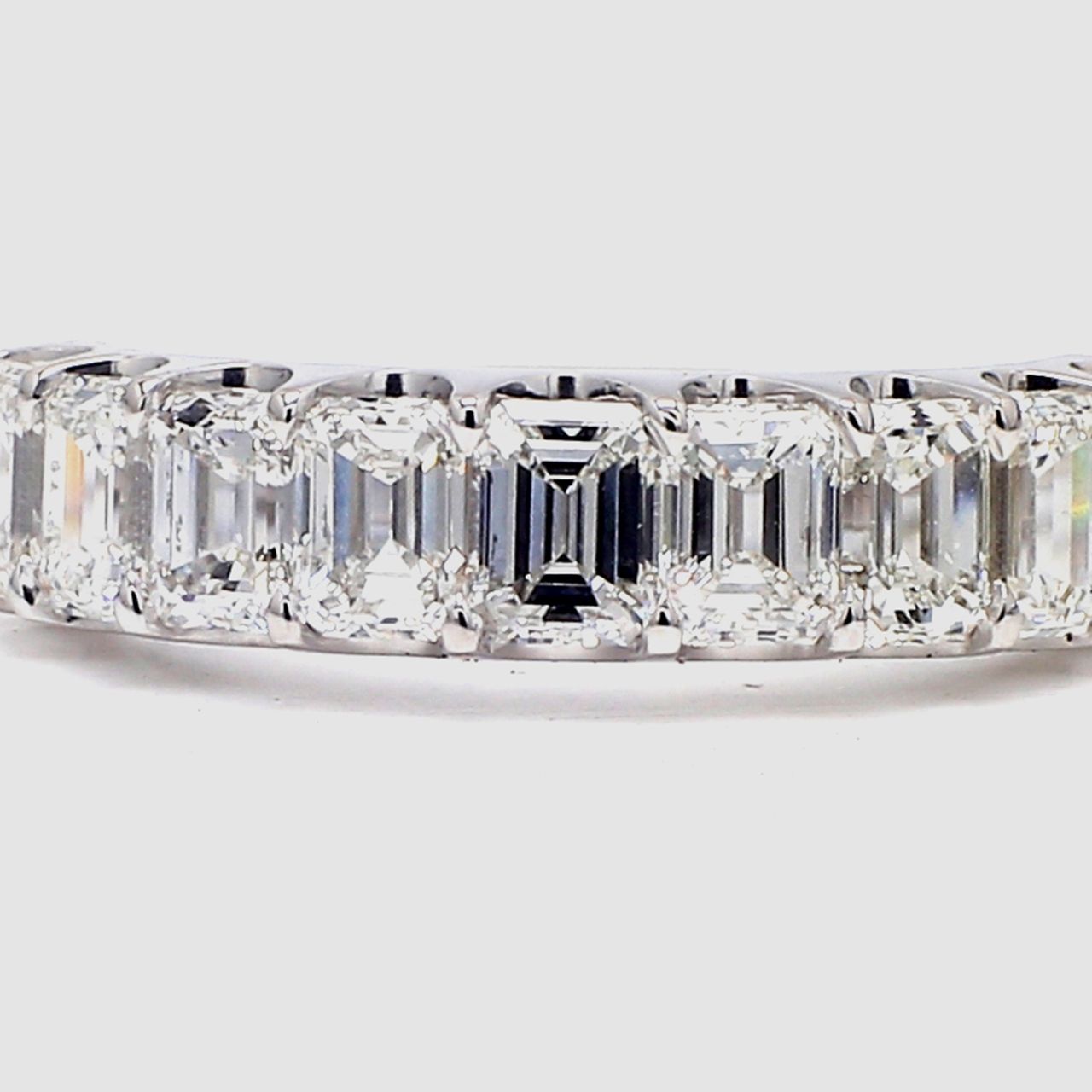 9-stone band in platinum with U-prong set emerald cut diamonds.  D2.75ct.t.w.  Size 7.5