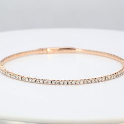 6.5' Lightweight flexible oval shaped bangle in 18K RG with prong set round diamonds.  D1.02ct.t.w.