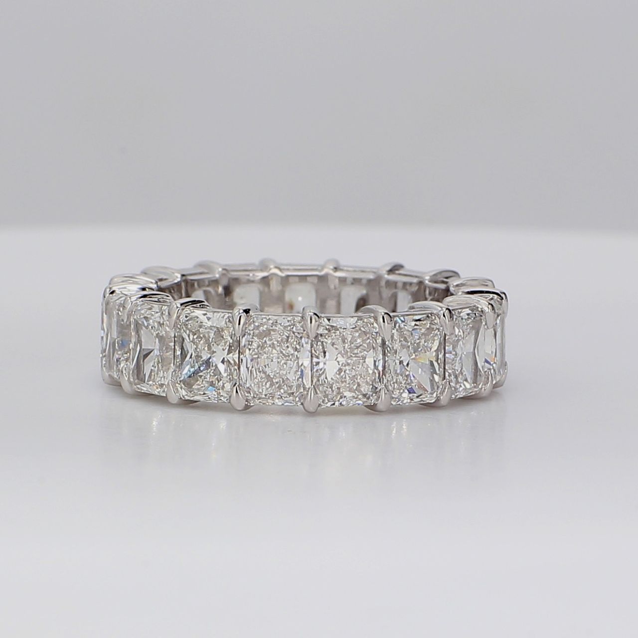 Eternity band in platinum with eagle claw prong basket set D-F/VVS1-VS2 (17) radiant cut diamonds.  D7.24ct.t.w.  Size 6.75
