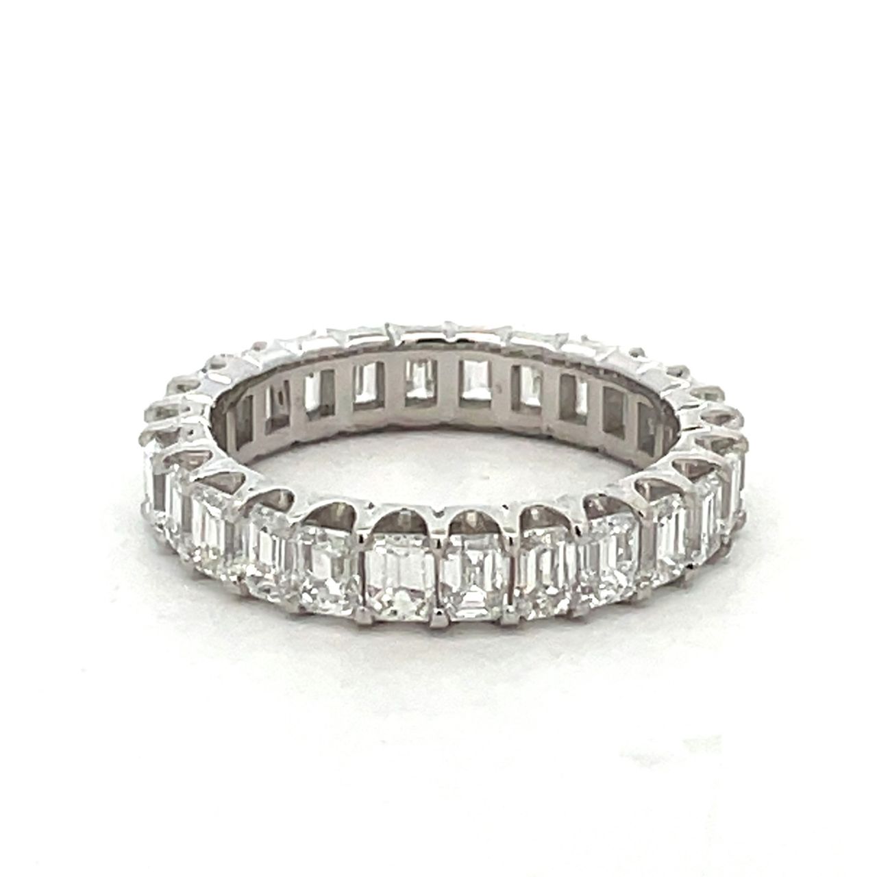 Eternity band in platinum with prong set (26) emerald cut diamonds.  D3.38ct.t.w.  Size 6