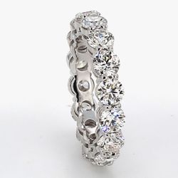 Eternity band in platinum w/ basket prong set (16) round diamonds.  D4.80ct.t.w.  Size 6.75