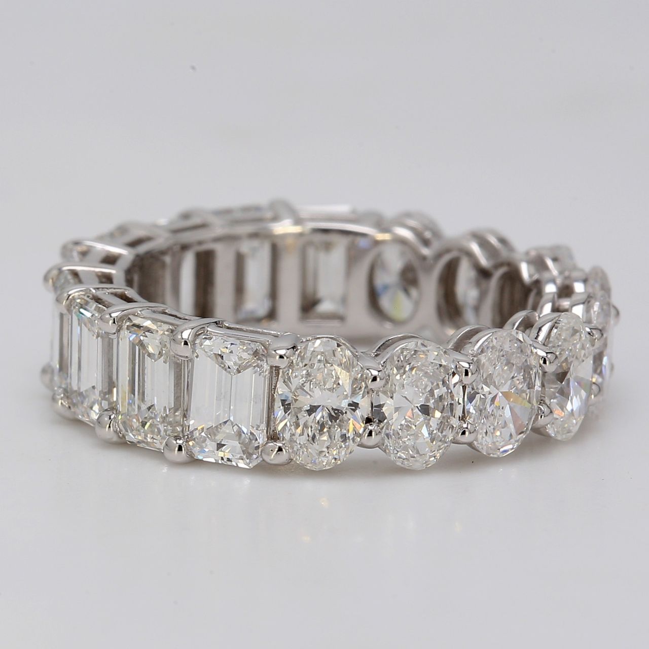 Eternity band in platinum with basket prong set VVS-VS oval & emerald cut diamonds.  D5.40ct.t.w.  Size 5.5