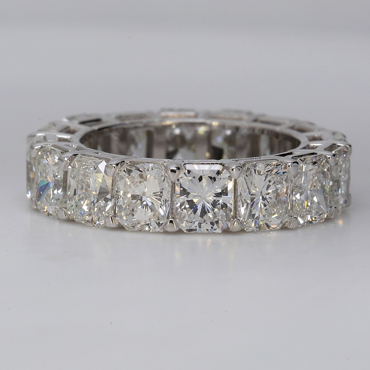 Eternity band in platinum with eagle claw prong set F+/VS+ (16) radiant cut diamonds.  D7.79ct.t.w.  Size 5.5
