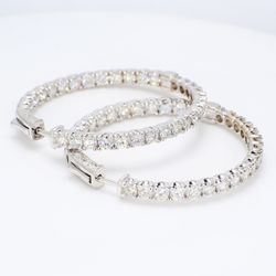 Inside out hoop earrings with prong set round diamonds.  D6.86ct.t.w.
