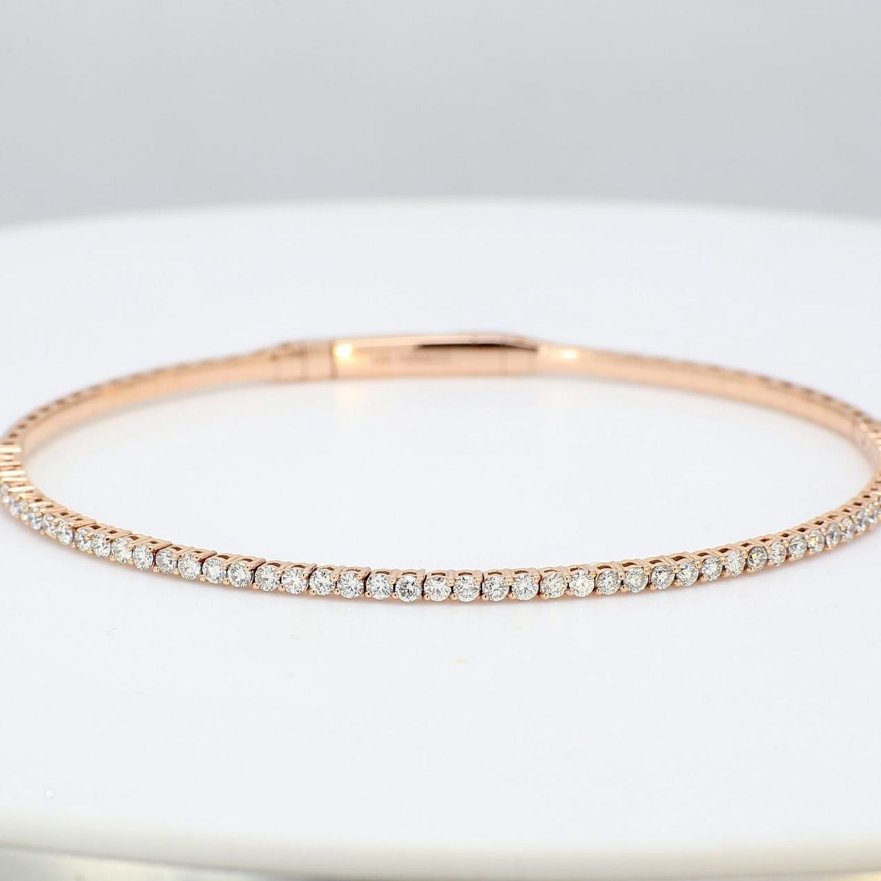 7'Lightweight flexible oval bangle in 14K RG with prong set round diamonds.  D1.04ct.t.w.