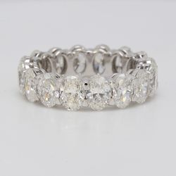 Eternity band in platinum with eagle claw basket set G-H/VS (16) oval diamonds.  D6.43ct.t.w.  Size 6.5