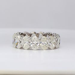 Eternity band in platinum with shared basket prong set G/SI (15) oval diamonds.  D7.74ct.t.w.  Size 6.25