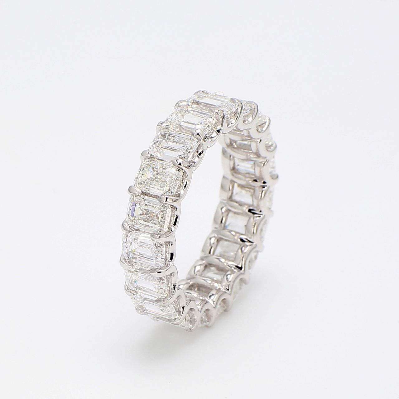 Eternity band in platinum with shared claw U-prong set GIA certified D-F/VVS2-VS2 (19) emerald cut diamonds.  D7.96ct.t.w.  Size 7
