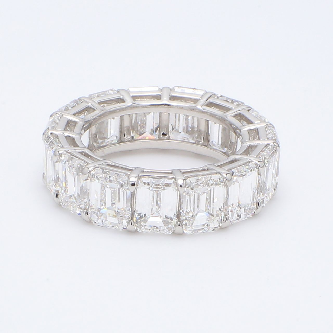 Eternity band in platinum with shared prong set emerald cut diamonds.  D8.79ct.t.w.