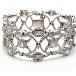 Halo designer bracelet in 18K WG with prong set rounds around fancy shaped diamond center stones.  D15.53ct.t.w.