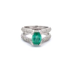 Split-shank ring in platinum with pave and bezel set round diamonds and 4-prong set oval shaped emerald center.  D1.25ct.t.w.  (Emerald - 1.22ct.)
