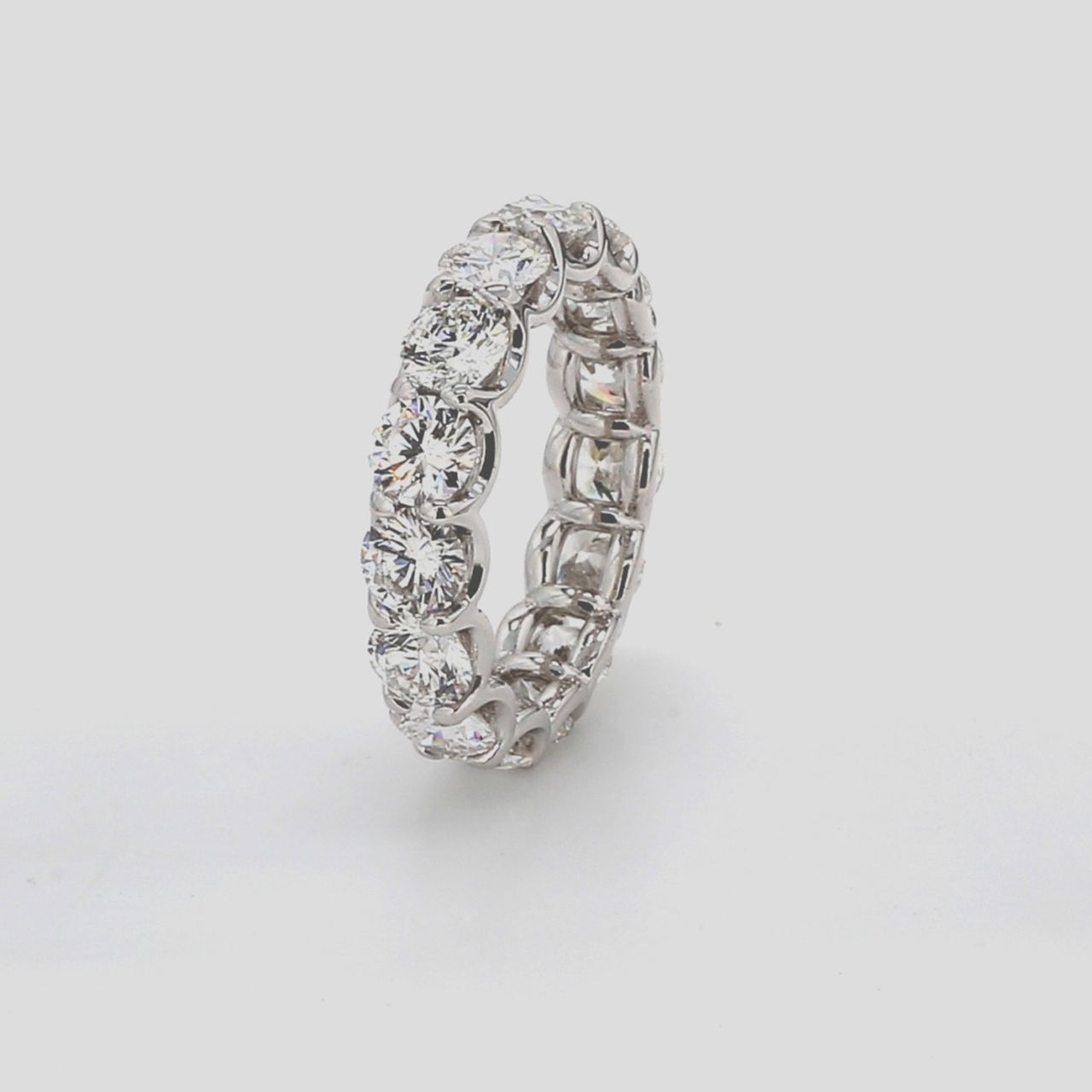 Eternity band in platinum with shared u-prong set E-F/VS1-SI1 (15) round diamonds.  D5.47ct.t.w.  Size 7.25