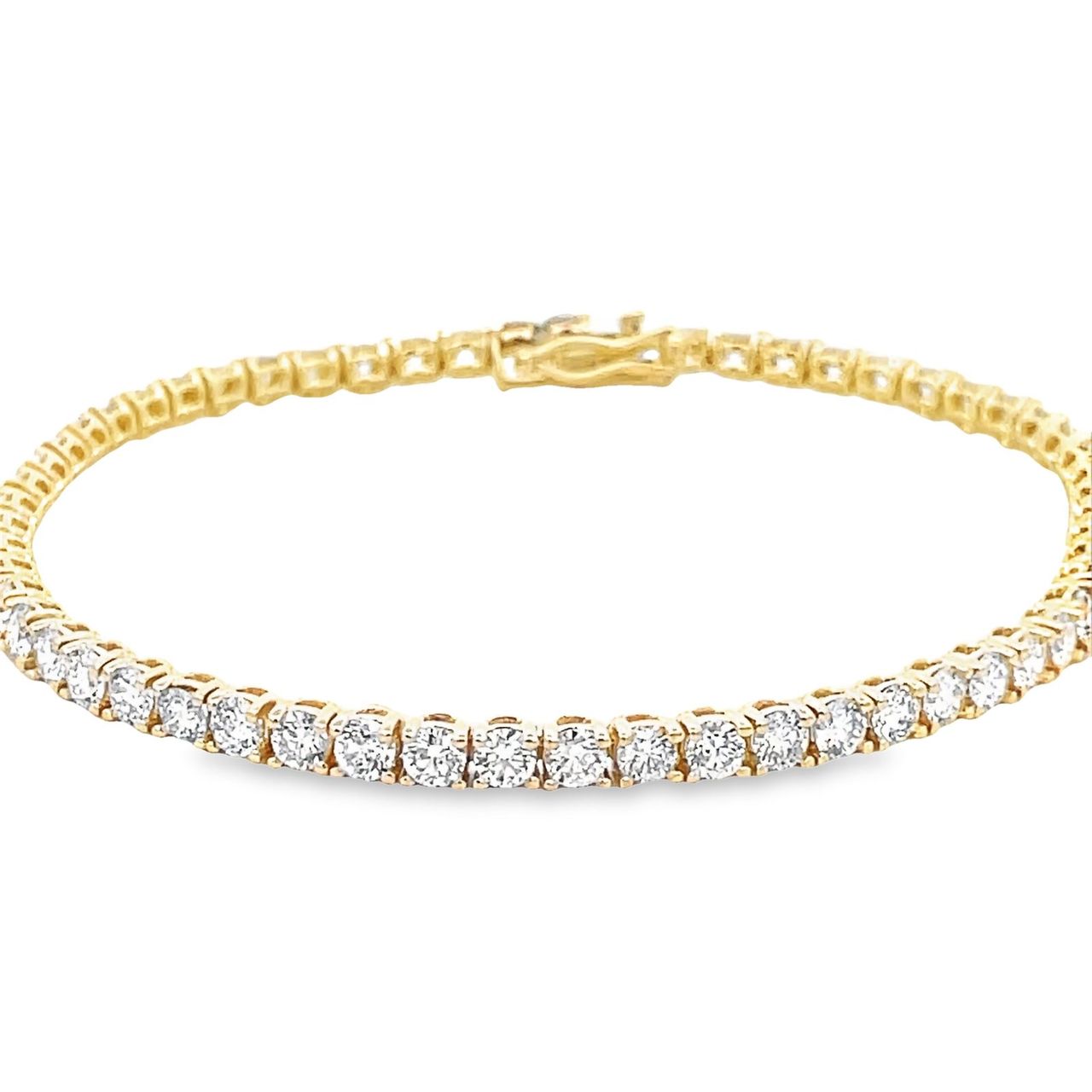 7' Tennis bracelet in 18K YG with open basket prong set (58) round diamonds.  D5.15ct.t.w.