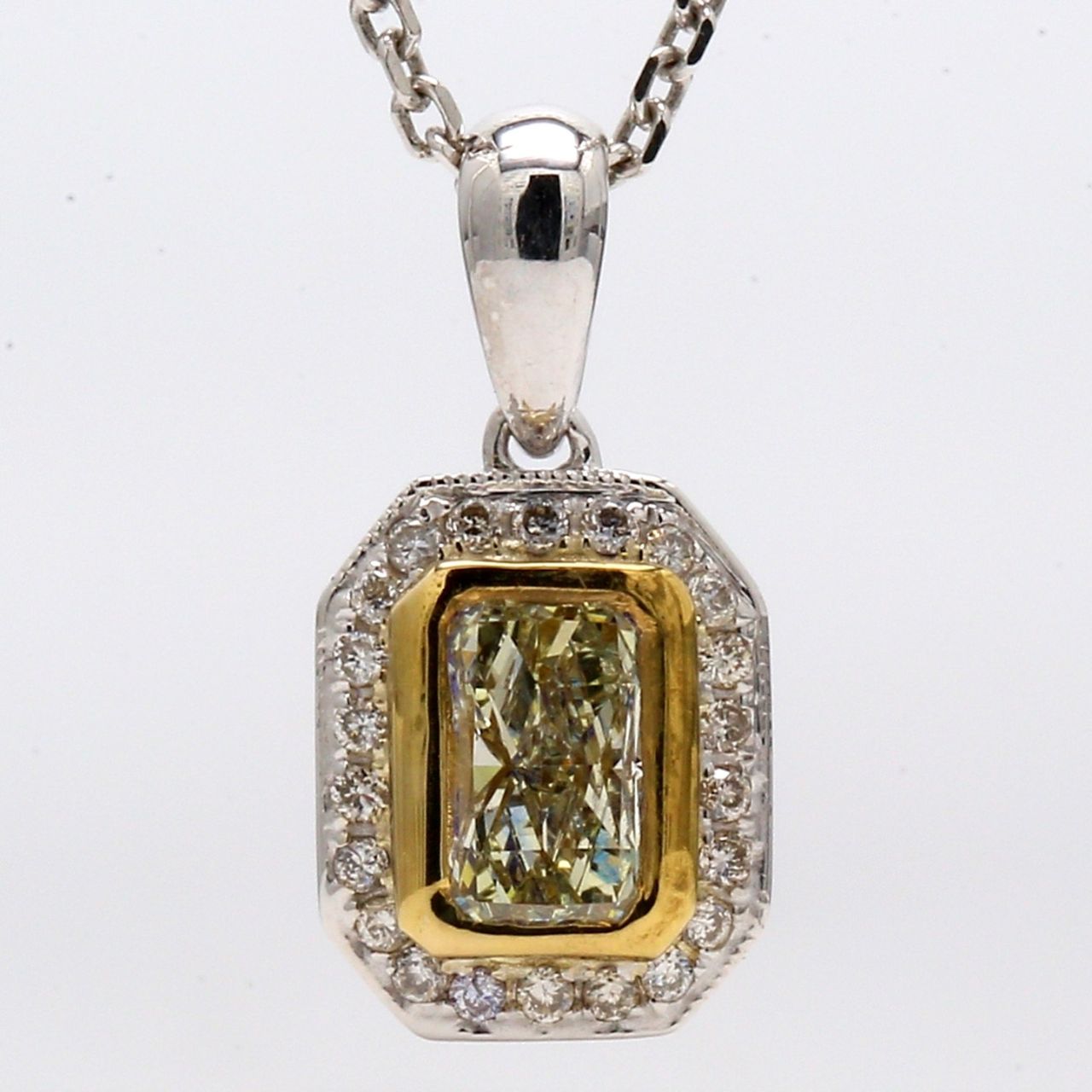 Halo pendant with pre-set rounds & square bezel set fancy yellow radiant diamond center.  D0.64ct.t.w.  (Center 0.52ct.)