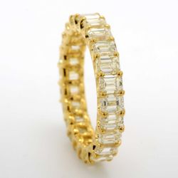 Eternity band in 18K YG with shared U-prong set FY/VS (24) emerald cut diamonds.  D4.41ct.t.w.  Size 6
