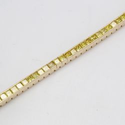 7' Tennis bracelet in 14K YG with channel set princess cut yellow diamonds.  D4.41ct.t.w.