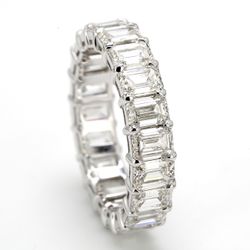 Eternity band in platinum with shared prong set emerald cut diamonds.  D6.48ct.t.w.  Size 7.25