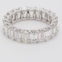 Eternity band in platinum with U-prong set (21) emerald cut diamonds.  D6.83ct.t.w.  Size 6.75