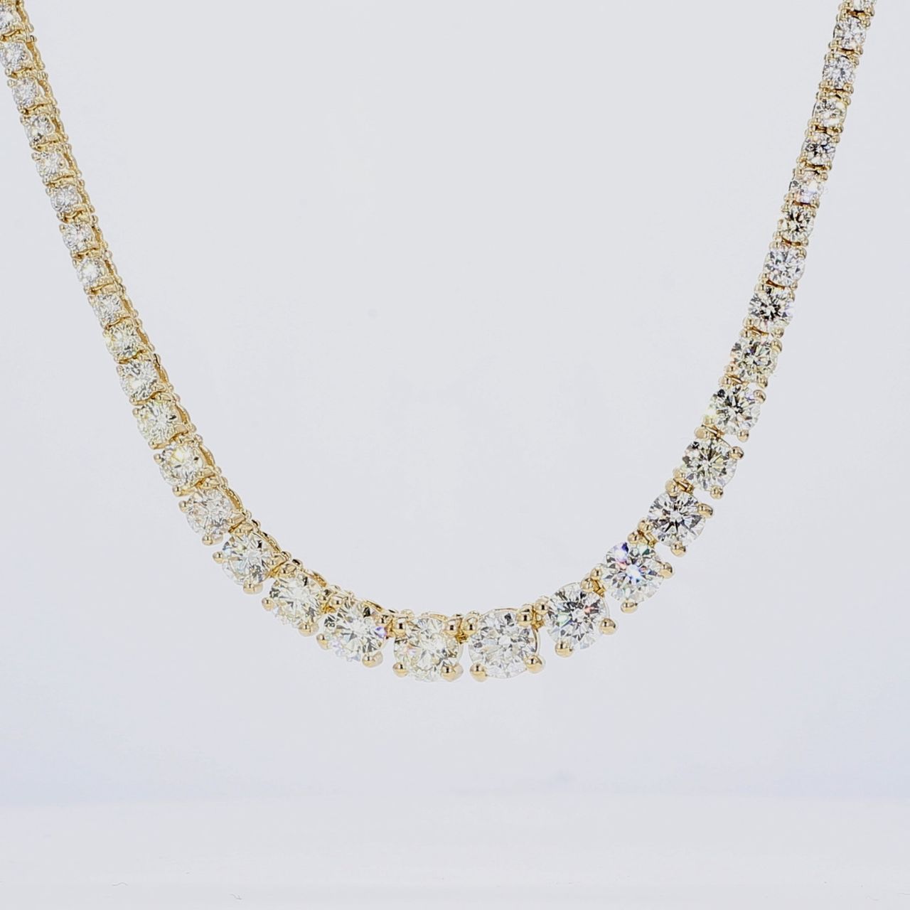 16' Half way graduated tennis necklace in 14K YG with 4-prong set round diamonds.  D5.56ct.t.w.