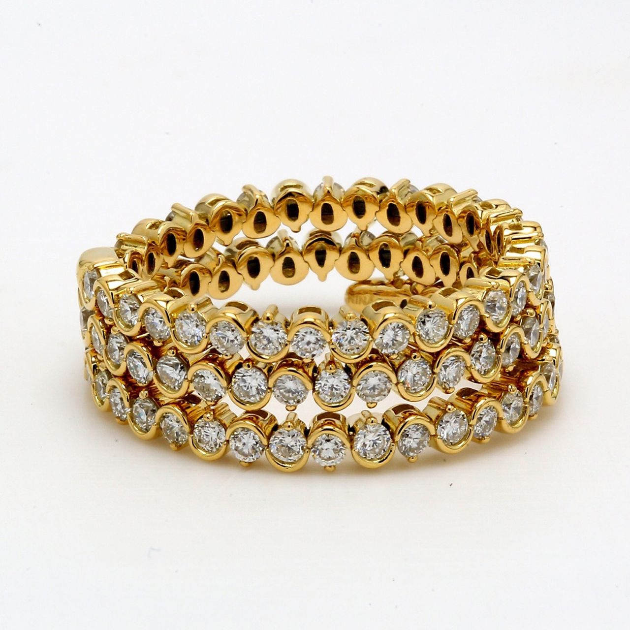 Flexible eternity tri-band style swirl band in 18k gold with pre-set round diamonds.  D1.43ct.t.w.