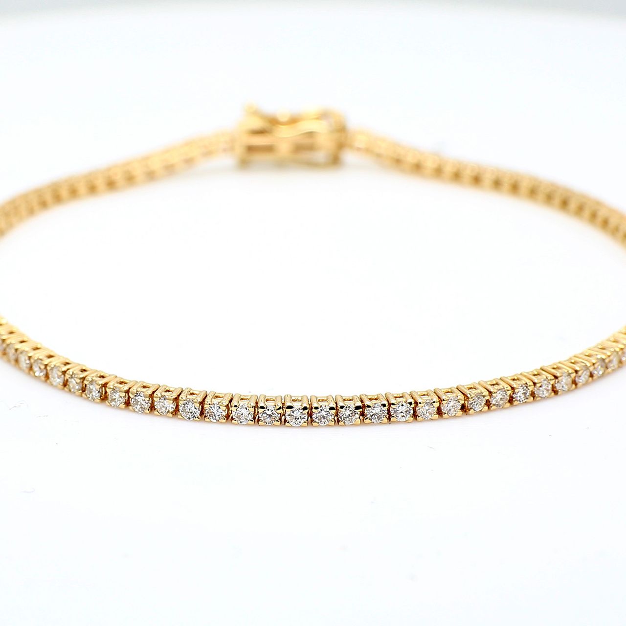 7' Tennis bracelet in yellow gold with basket prong set (92) round diamonds.  D1.41ct.t.w.