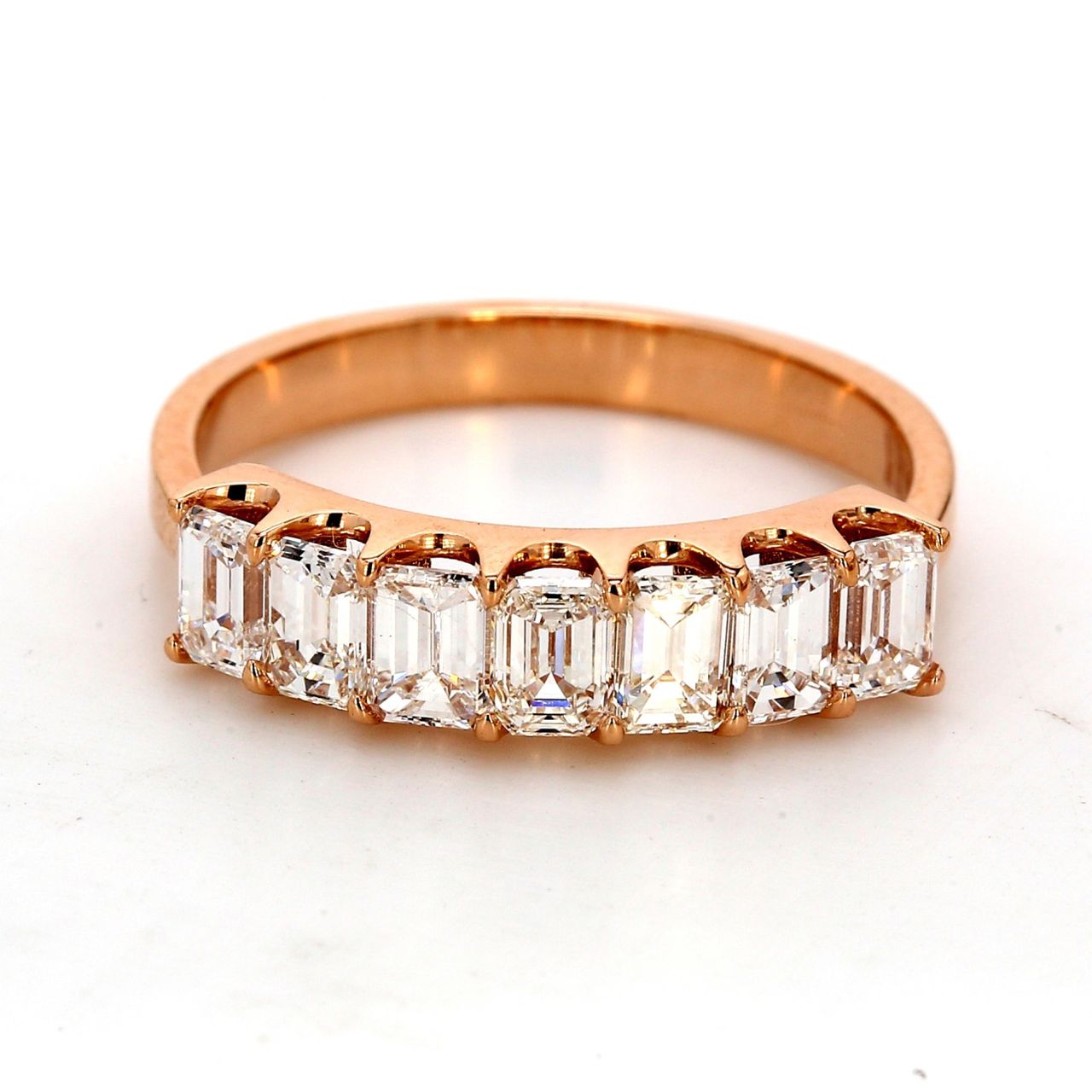 7-stone band in 18K RG with shared prong set emerald cut diamonds.  D1.34ct.t.w.  Size 6.25