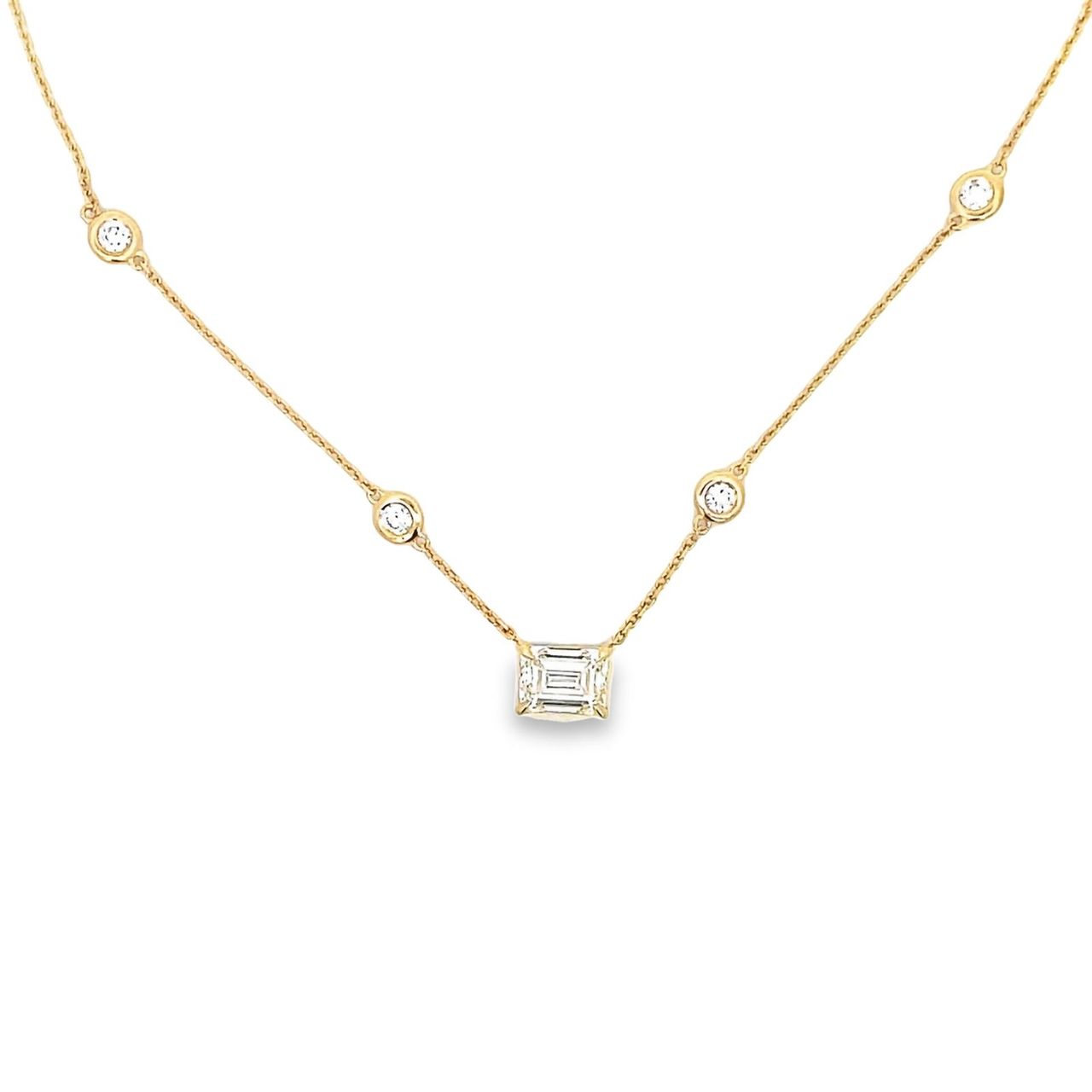 16' Diamonds by the yard necklace in 14K YG with bezel set (10) rounds and 4-prong set GIA certified M/VVS2 emerald diamond center.  D2.69ct.t.w.  (Center - 1.81ct.)