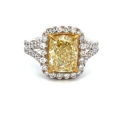 Halo split shank ring in platinum with shared prong set rounds and claw 4-prong set FY/VS2 GIA certified cushion diamond center.  D3.84ct.t.w.  (Center - 3.06ct.)  Size 6.25