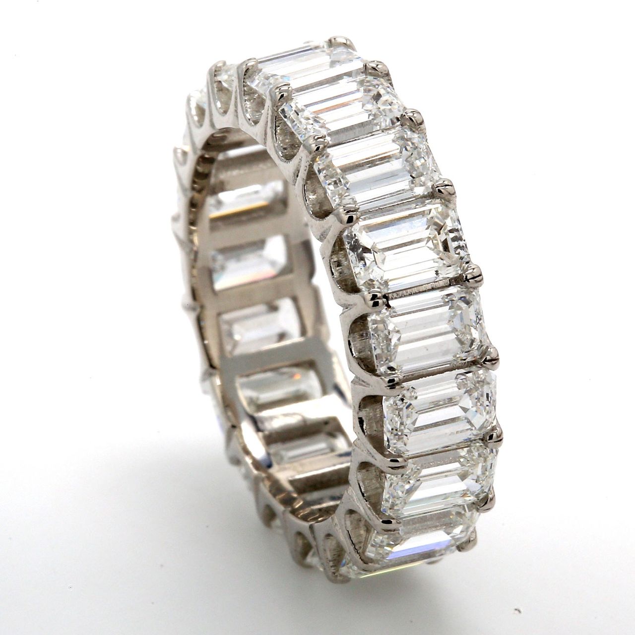 Eternity band in platinum with U-prong set (19) emerald cut diamonds.  D5.90ct.t.w.  Size 5