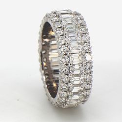 Eternity band in 18K WG with combination prong set emeralds and round diamonds.  D4.30ct.t.w.  Size 4.75