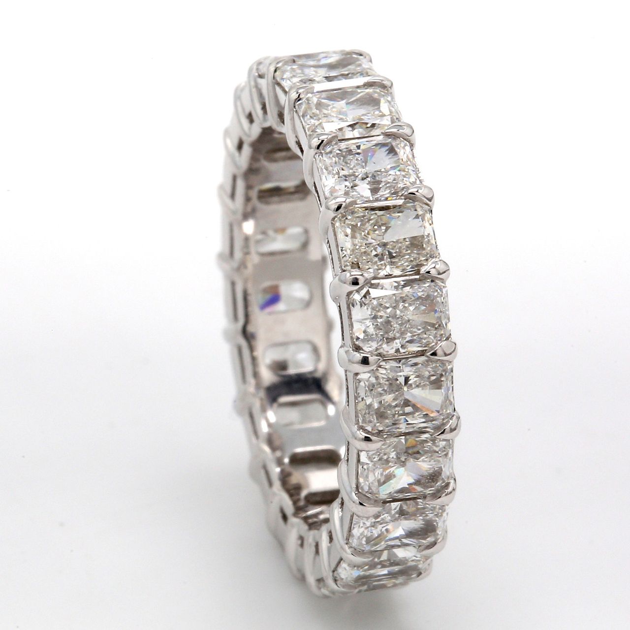 Eternity band in platinum with basket claw prong set F/VS (21) radiant cut diamonds.  D5.07ct.t.w.  Size 6