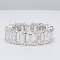 Eternity band in platinum with basket prong set D-F/VVS (16) emerald cut diamonds.  D11.78ct.t.w.  Size 6