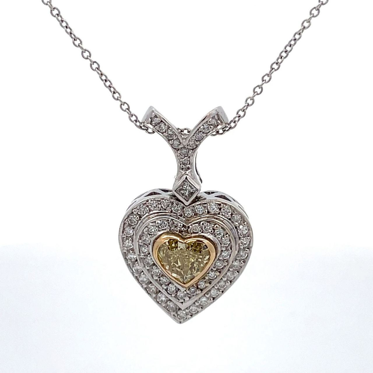Double halo drop heart pendant with pave set rounds, square bezel set princess cut, & bezel set heart shape diamond center.  D1.37ct.t.w.