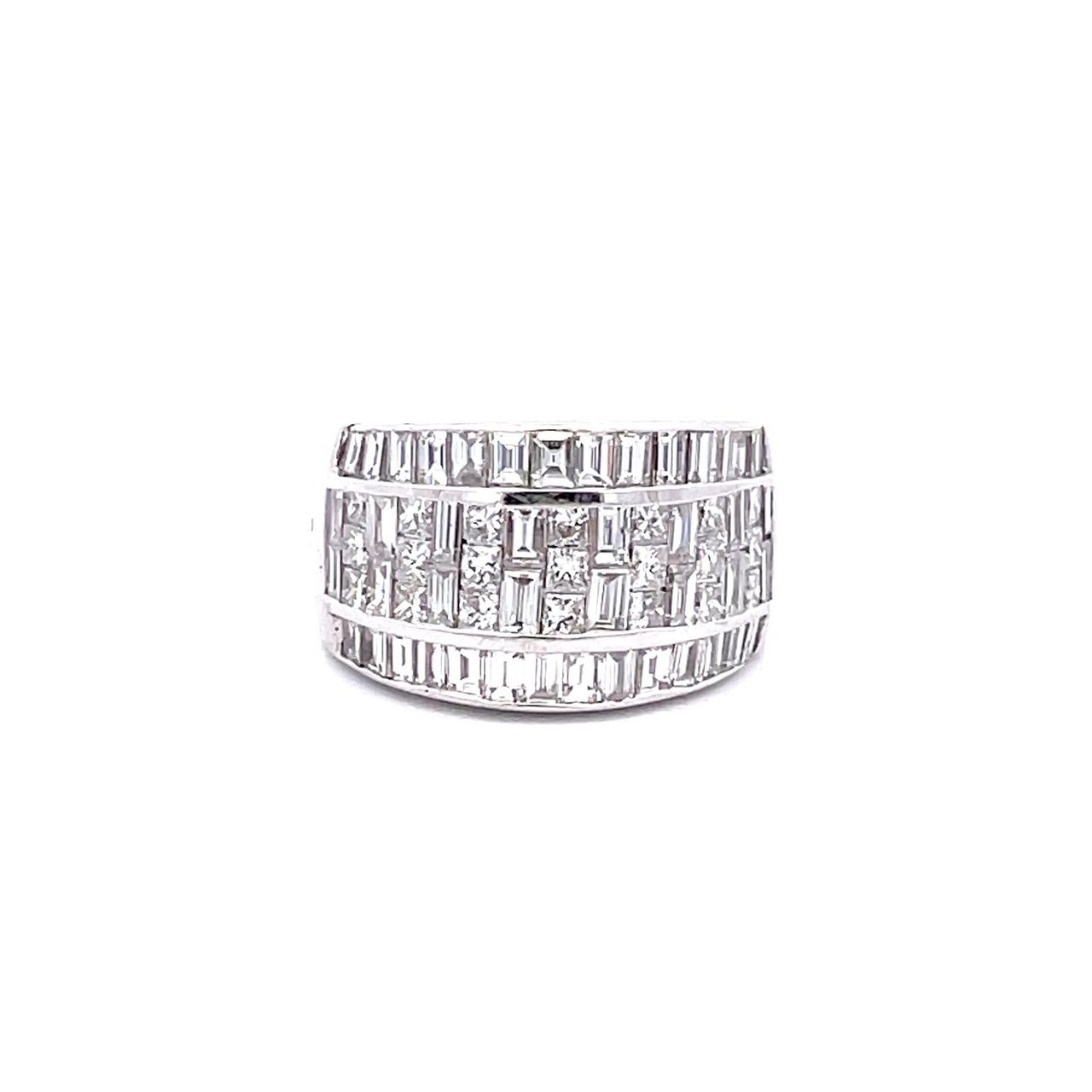 Wide band with invisible set combination princess cuts and baguettes on the center & channel set baguette diamonds on the sides.  D2.87ct.t.w.