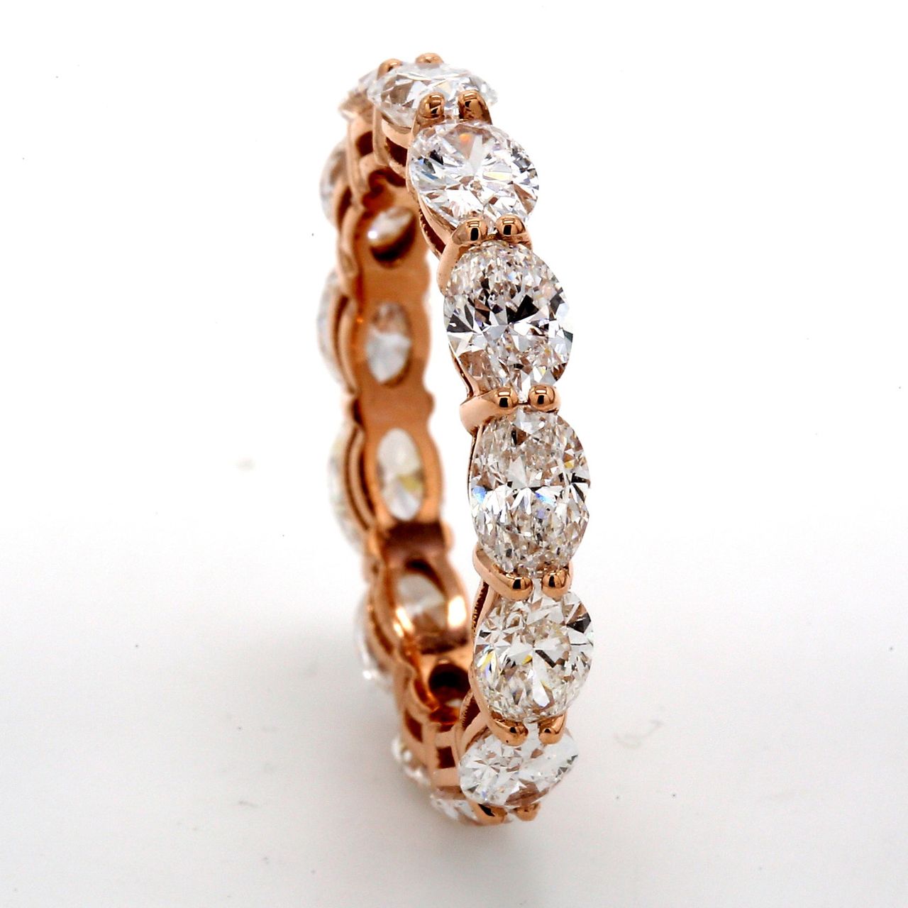 Eternity band east to west style in 18K RG with basket set (13) oval cut diamonds.  D3.14ct.t.w .  Size 5