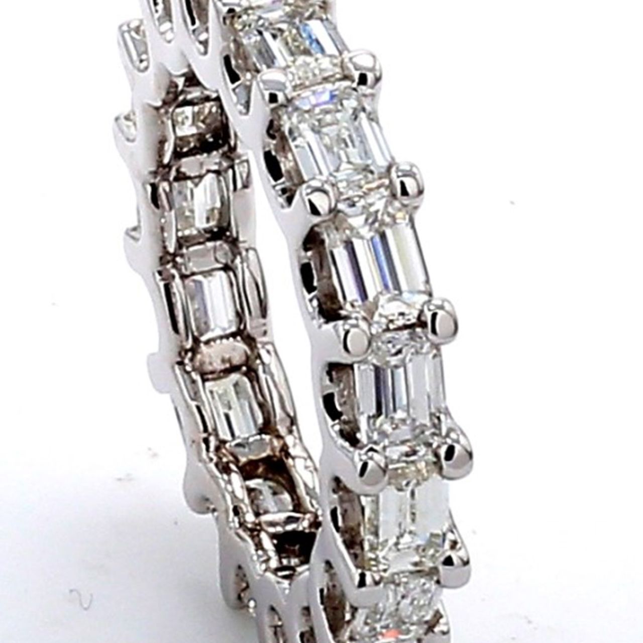 East to west style eternity band with U-prong set (17) emerald cut diamonds.  D3.26ct.t.w.  Size 5