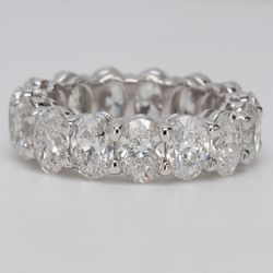 Eternity band in platinum with shared prong set (15) oval diamonds.  D7.71ct.t.w.  Size 6