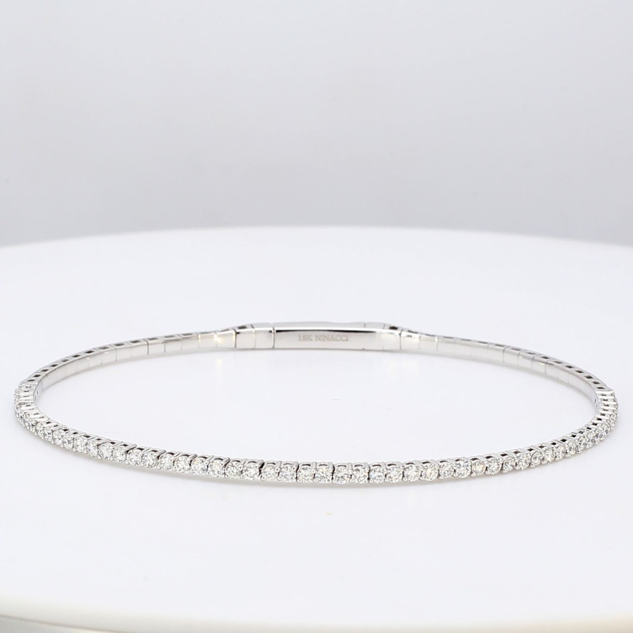 7' Lightweight flexible oval bangle with prong set round diamonds.  D1.04ct.t.w.