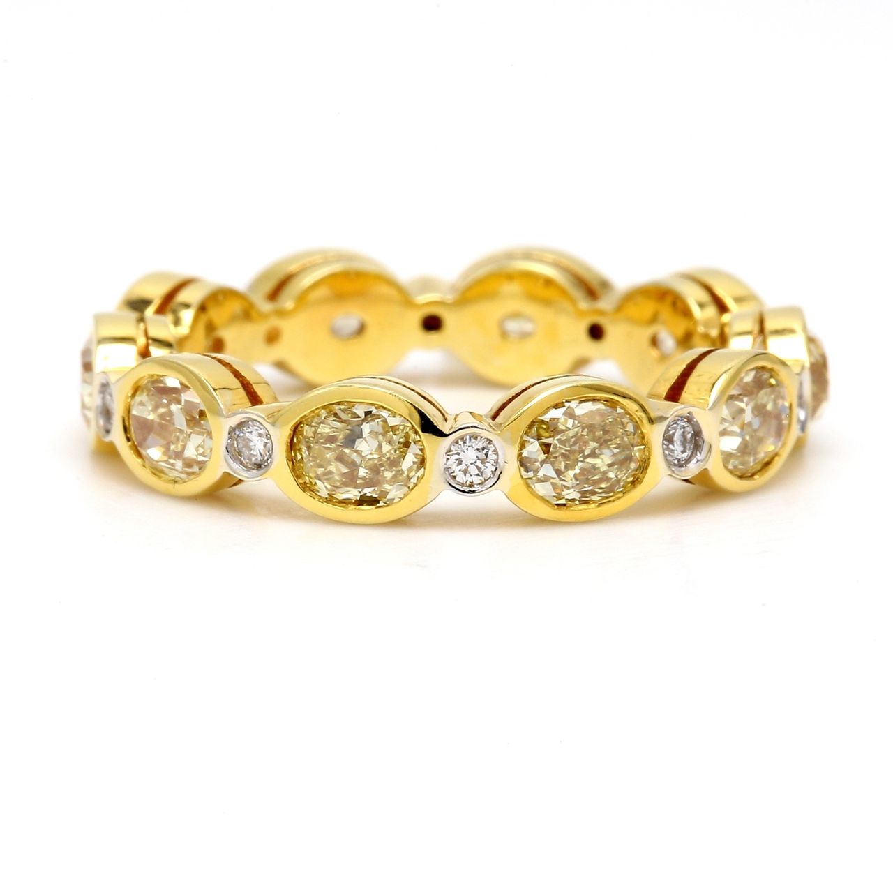 Eternity band in 18K YG with alternating bezel set rounds & fancy yellow oval diamonds.  D3.29ct.t.w.  Fancy Yellow 3.14ct.t.w.  Size 7