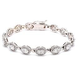 7' Designer bracelet with shared prong set rounds and 4-prong set oval cut diamonds.  D6.96ct.t.w.