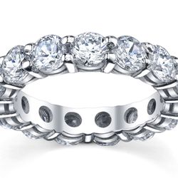 Eternity band with shared 4-prong set (14) round diamonds.  D4.54ct.t.w.  Size 5.25