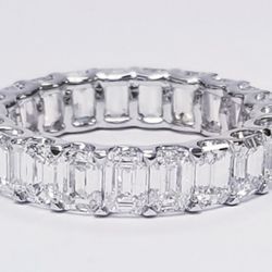 Eternity band in platinum with shared U-prong set (23) emerald cut diamonds.  D5.74ct.t.w.  Size 6