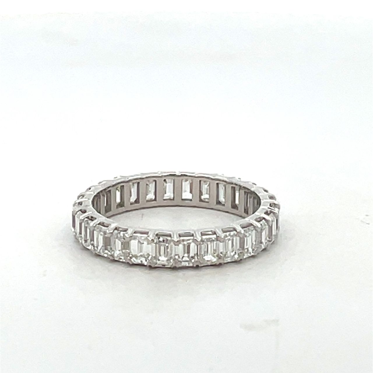 Eternity band in 18K WG with prong set (28) emerald cut diamonds.  D2.46ct.t.w.  Size 5.5